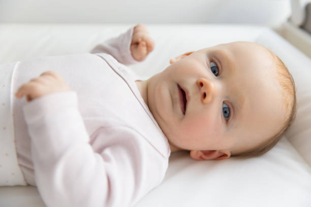 istock Adorable surprised red-haired baby looking at something 1214859562