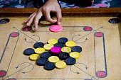 istock A game of carrom with pieces carrom man on the board carrom. Carom board game, selective focus. 1214861047