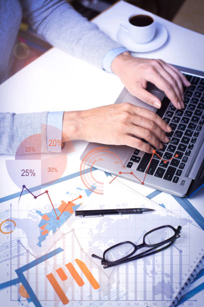 istock Businesswoman working on laptop with financial analysis graphs 1214862497