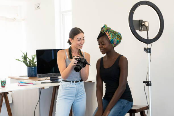 istock Young photographer showing model shots on camera 1214864515