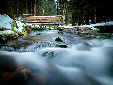 Spectacular long-term recording of a small water course with a wooden bridge