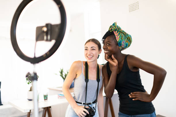 istock Young photographer and model pose for camera in home vlogging studio 1214864597