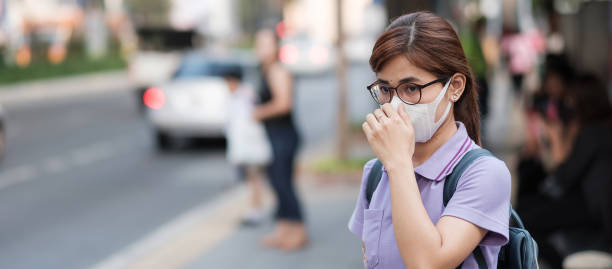 istock Woman Wearing Mask Standing On Sidewalk 1214869224