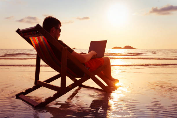 istock freelancer business man working on computer in beach office 1214869970