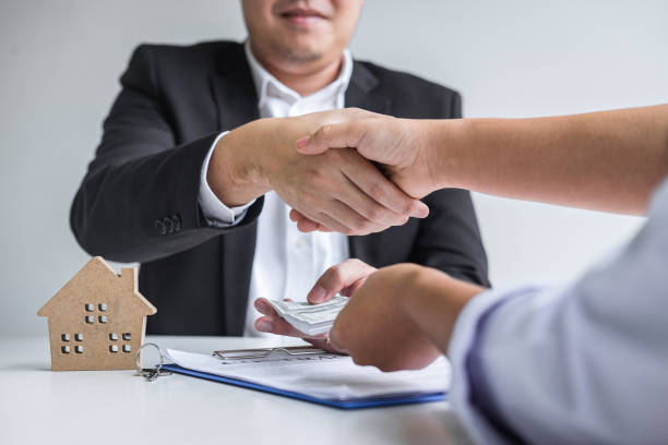 istock Midsection Of Real Estate Agent Shaking Hand With Client In Office 1214871155
