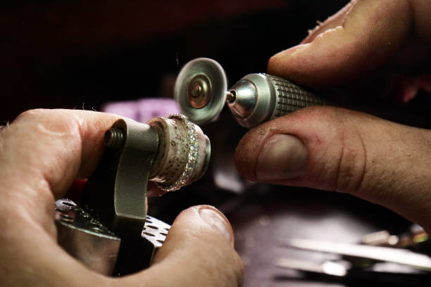 istock Close up of a goldsmith's hand making a gold or silver ring or a diamond using goldsmith's tools 1214874006