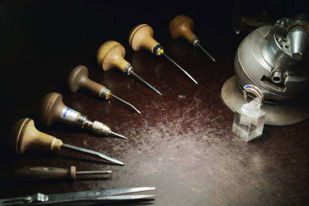 istock Close up of a goldsmith's hand making a gold or silver ring or a diamond using goldsmith's tools. For this work it takes precision and patience 1214874021