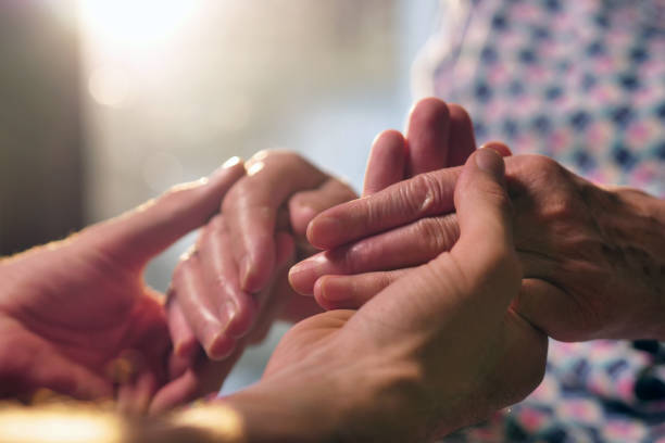 istock young person helps her grandmother to get up taking her hands. 1214876556