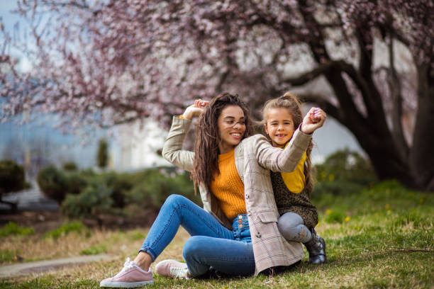Day full of smile. African American mother with her daughter at the park.