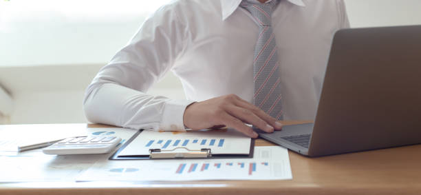 istock Midsection Of Businessman Using Laptop In Office 1214880850