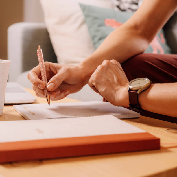 istock Woman working at home checking time on her smart watch 1214882095