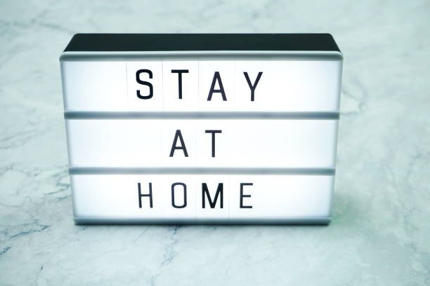 istock Stay at Home word letter in light box on marble background 1214882425