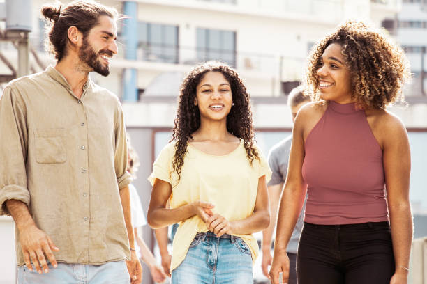 istock Smiling friends walking outdoors 1214882494