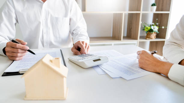 istock Midsection Of Real Estate Agent And Customer Having Discussion In Office 1214882981