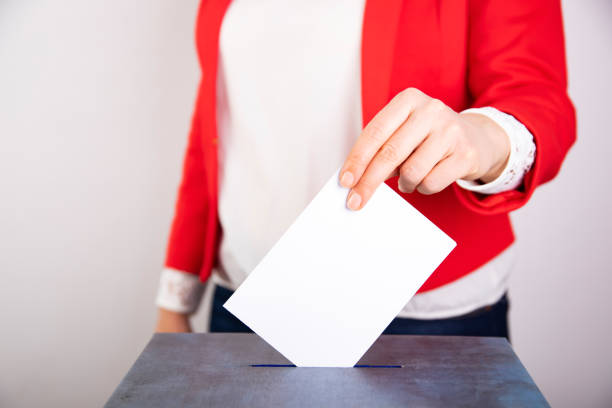 Woman votes on election day. stock photo