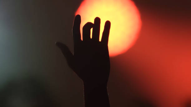 istock Cropped Silhouette Hand Against Sun At Sunset 1214886721
