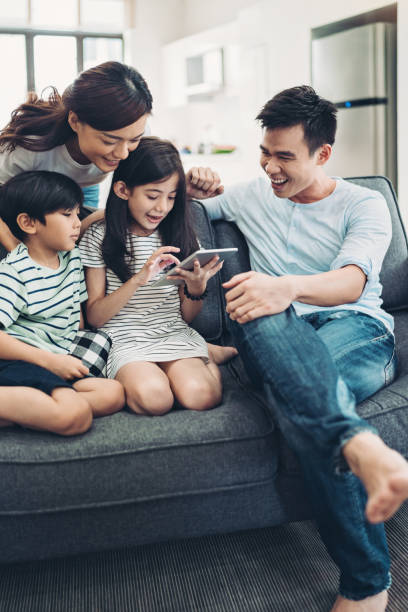 istock Family using digital tablet at home 1214886769