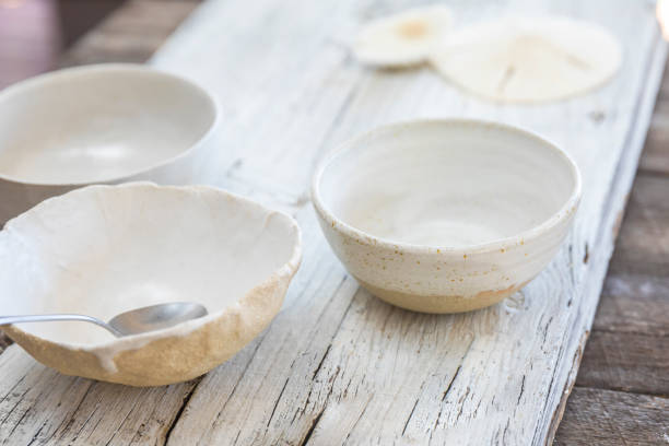 istock White serving bowls on wooden table 1214887360