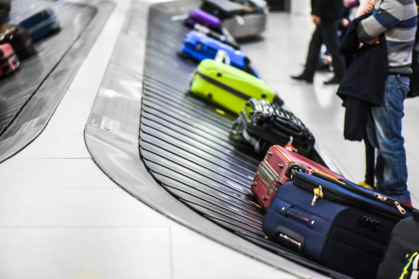 istock Suit case conveyor belt at airport baggage 1214887991