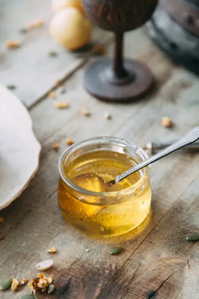 Cooking with honey. Transparent yellow jam. Natural honey in a glass jar.