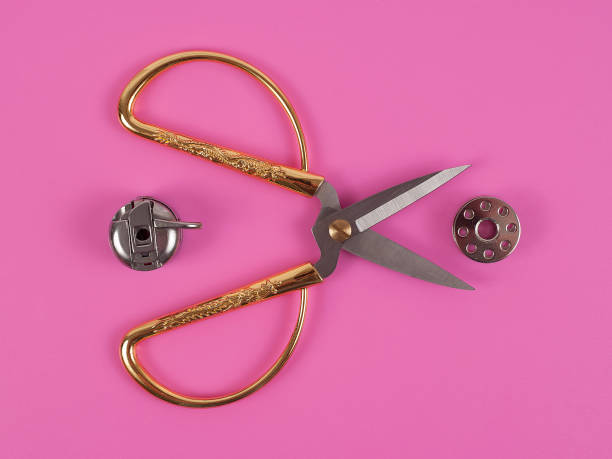 Accessories for sewing thread scissors needle and centimetre on a pink background Accessories for sewing thread scissors needle and centimetre on a pink background centimetre stock pictures, royalty-free photos & images