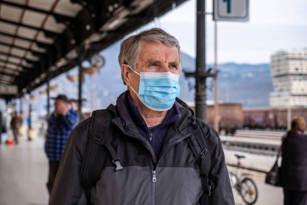 istock Senior man traveling with face mask 1214894383