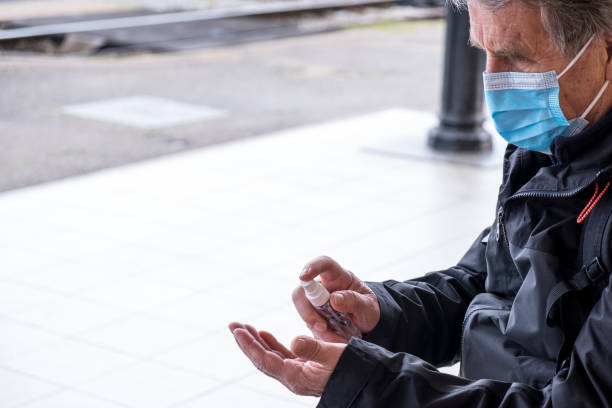 istock Man disinfecting his hands due to coronavirus risk 1214894640