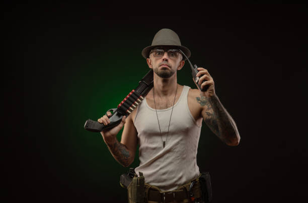 istock athletic guy with a tattoo poses with a shotgun 1214894714