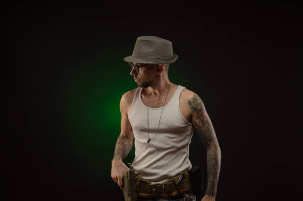 istock an athletic guy with a tattoo poses with a gun 1214894738
