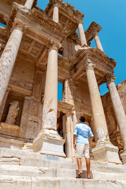 Ephesus, Turkey People are observing ruins of Celsus in Ephesus Ancient City in Turkey. men visit Ephesus Ephesus, Turkey People are observing ruins of Celsus in Ephesus Ancient City in Turkey during Summer, men visit Ephesus vacation celsus library photos stock pictures, royalty-free photos & images