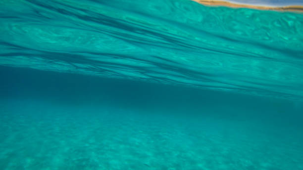 istock Sandy underwater sand on a shallow seabed in the Mediterranean sea with reflections of sunlight 1214896190