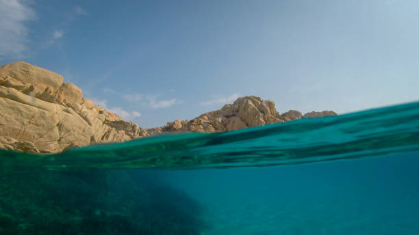istock View over and under water surface, rocks and blue sky, mediterranean sea, split by waterline 1214896191