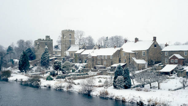West Tanfield, North Yorkshire, England, UK in the snow. West Tanfield, North Yorkshire, England, UK in the snow. 1991 north yorkshire photos stock pictures, royalty-free photos & images