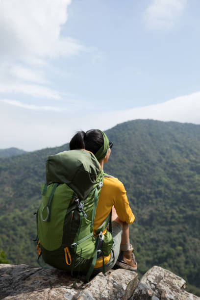 istock Successful hiker enjoy the view on mountain top cliff edge 1214897978