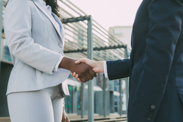 istock Successful businesswomen shaking hands outside 1214898384
