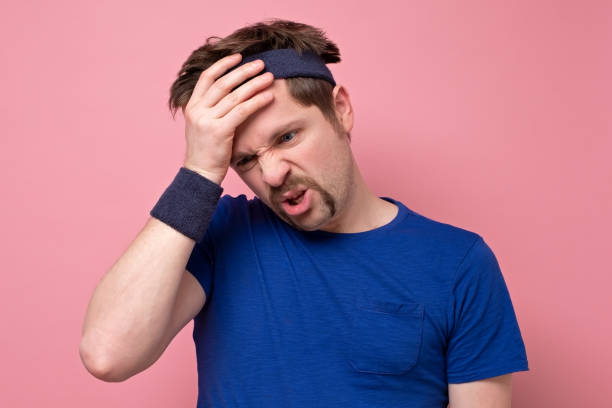 istock Fatigue sportsman wipes sweat on forehead, has unhappy look, had active training 1214900058