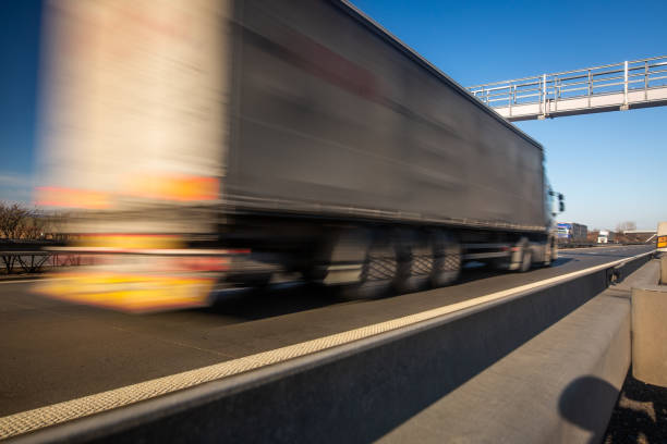 istock Truck passing through a toll gate on a highway, highway charges, motion blurred image 1214900803