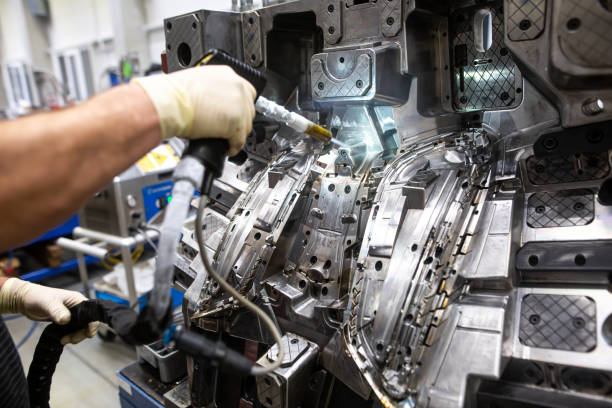istock Engineer doing maintenance on the injection mold after production by dry nitrogen, industrial concept 1214901151