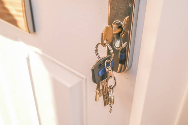 istock Close up of front door key in lock 1214902779