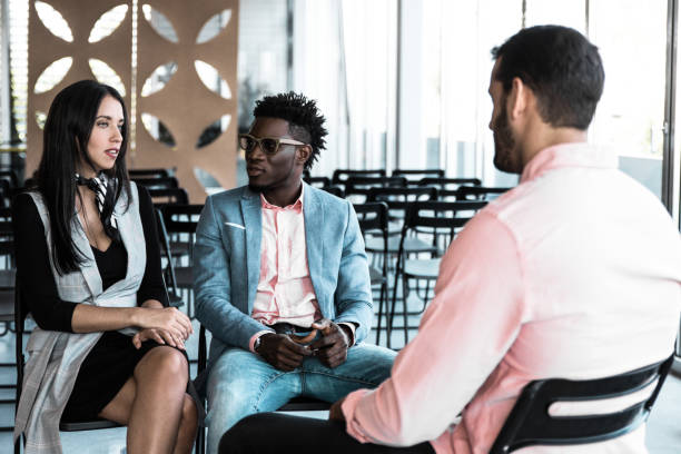 istock Serious coworkers discussing ongoing project together 1214902994