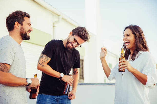 istock Excited happy friends drinking beer, chatting and laughing 1214903221