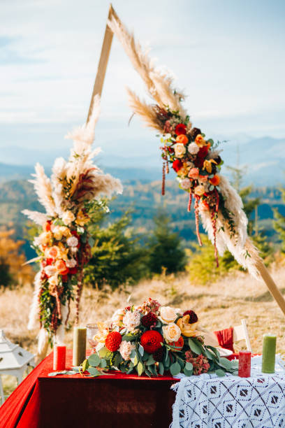istock Triangular wooden arch with composition of pampasian grass, dahlia and roses. 1214904092