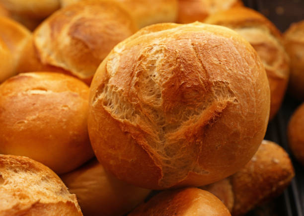 istock Close up fresh wheat bread buns on retail display 1214904222