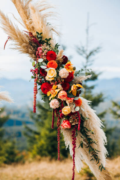 istock Elements of wedding arch in rustic style on mountains background 1214904415