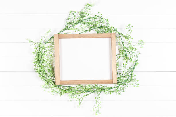 istock wooden frame mockup with greenery on a light background 1214904592