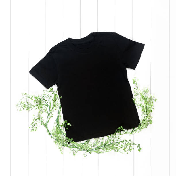 istock Black t-shirt with short sleeves and green branches 1214904626