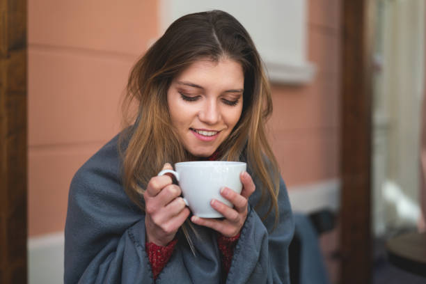 istock Young woman drinking coffee or tea 1214904641