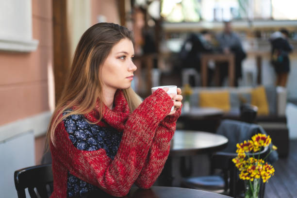 istock Young woman drinking coffee or tea 1214904659