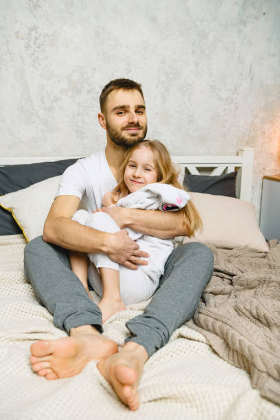 istock Father and daughter have fun in bed 1214904774