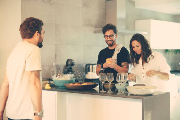 istock Happy couple cooking dinner for friends 1214906458